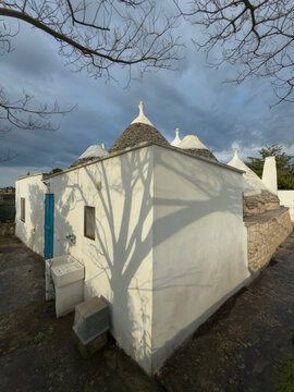 Locorotondo village, white houses with a central dome and spire, built in the Puglian traditional style.