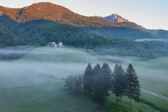 Tjenti&scaron;te War Memorialin Early Morning Fog, in Sutjeska National Park, site of a battle in 1943, two shaped concrete rock sculptures shrouded in mist.