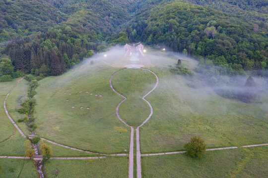 Tjenti&scaron;te War Memorial in Early Morning Fog, in Sutjeska National Park, site of a battle in 1943, two shaped concrete rock sculptures shrouded in mist.