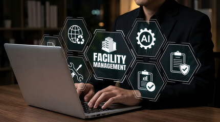 Fototapeta premium Business professional using laptop with Facility Management virtual interface