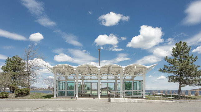 Access to a dock or marina mooring on the coastline of Quincy, a building with curved roof and glass doors.