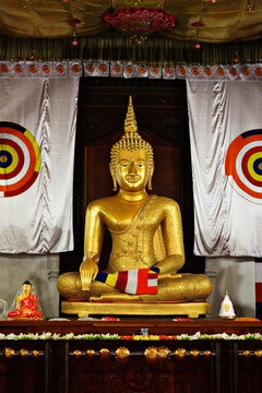 A sitting Buddha statue in Temple of the Tooth. Kandy, Sri Lanka