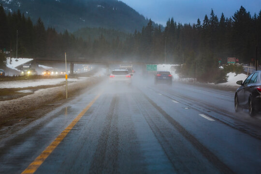 Northbound in winter on Highway 97 over Blewett Pass, Cascade Mountains, mist and spray on the road, driving conditions.