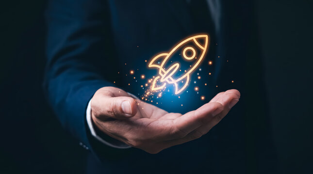 Businessman holding a glowing rocket icon in his hand, concept for business startup, growth, success, and innovation