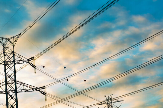 High transmission towers and wires, low angle view.