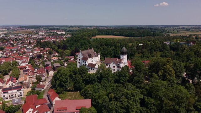 Aerial summer view of Voehlinschloss in Illertissen, Bavaria, Germany, capturing the castle hill, town roofs and layout in Neu Ulm district