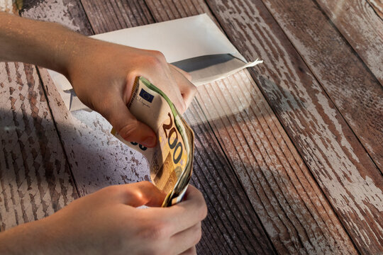 cash payment with euro banknotes and envelope