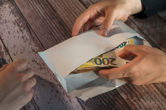 euro banknotes hidden in envelope bribe concept