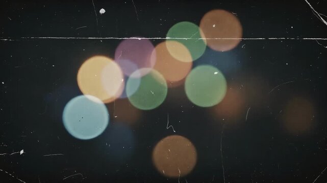 Dreamy video of softly glowing firefly lights dancing on dark background evoking warm nostalgic feelings