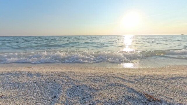 Sea water reflecting golden hour light at Mari Ermi beach, Sardinia, Italy