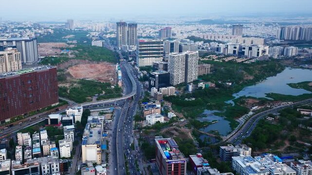 Aerial view of Biodiversity junction, with flyovers, park, skyscraper, The Skyview and Khajaguda Talab at Gachibowli, hyderabad, telangana, india. day time, stable shot, drone shot, 4k.