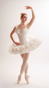 Elegant ballerina in a white tutu gracefully poses in a studio setting. A beautiful ballerina is captured mid-pose, showcasing the elegance and artistry of ballet