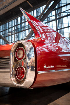 Low angle view of a Cadillac Coupe de Ville tail fin featuring dual taillights, chrome trim, and signature 1950s aerodynamic styling.