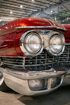 Low angle detail of a 1959 Cadillac front fascia featuring stacked dual headlamps, chrome grille, bumper, and jet-age styling.