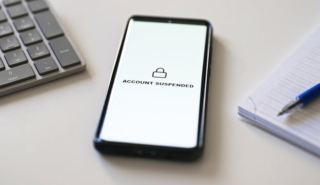 Bank account suspended message on smartphone screen.