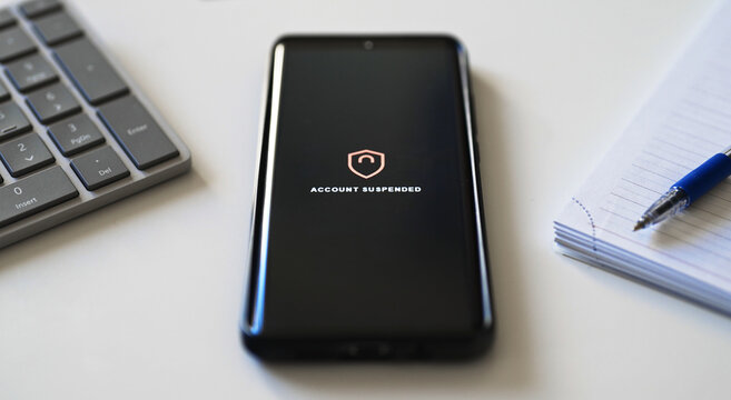 Bank account suspended message on smartphone screen.