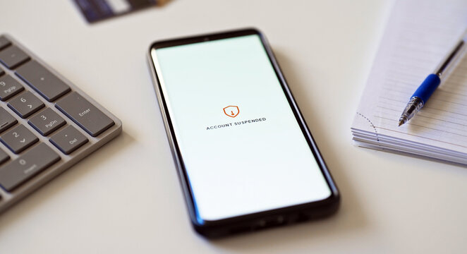 Bank account suspended message on smartphone screen.