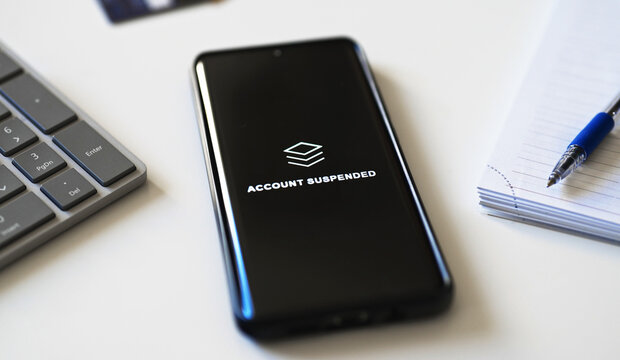 Bank account suspended message on smartphone screen.