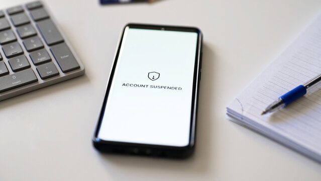 Bank account suspended message on smartphone screen.