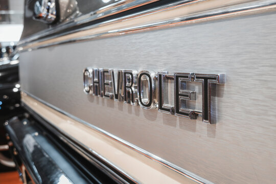 Close-up perspective shot of a chrome Chevrolet emblem on the brushed metal tailgate of a K5 Blazer.