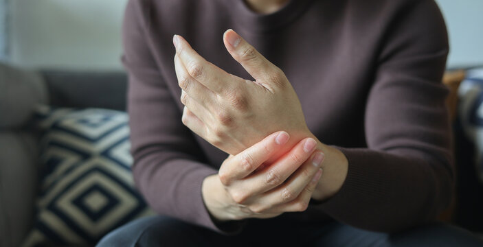 close up employee man massage on his hand and arm for relief pain from hard working ,carpal tunnel syndrome concept