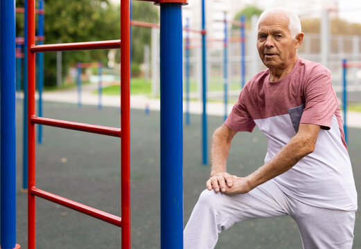 Old man stretching outdoors