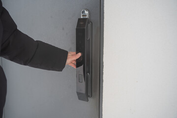 Naklejka premium Smart Lock On Gray Street Door Opens With Fingerprint