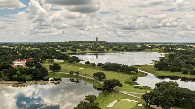 Aerial timelapse of Bok towers overlooking lakes and scenic nature in Lake Wales, Florida, United States.