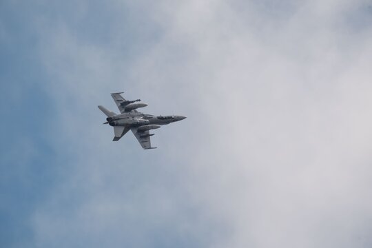 Albacete, Spain - June 12, 2026: An F 18 fighter jet flying over Los Llanos Air Base with clouds in the distance