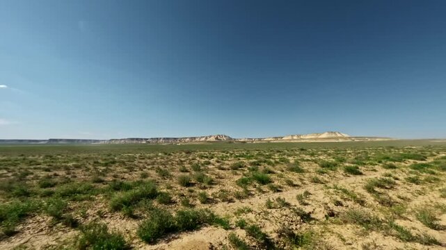 SUV driving off-road through rugged terrain with expansive landscape views