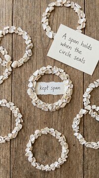Handmade Pale Seashell Wreaths Arranged on a Wooden Surface with Handwritten Notes for Low Attention Span