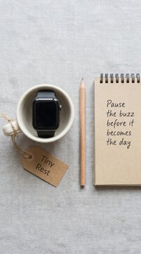 Smartwatch in a Cup with Notebook and Pencil: A Digital Detox Reminder