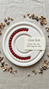 White Ceramic Dish with Red Beads Forming a Path for Blood Donation Choices