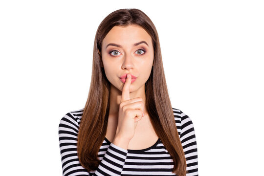 Portrait of minded girl looking with her index finger near face wearing striped pullover isolated over white background