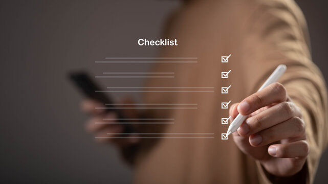 Close-up of a hand completing a digital checklist with a stylus, symbolizing task management, productivity, project planning, workflow organization, business efficiency, and goal achievement.