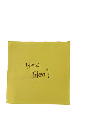 Yellow sticky note with New Idea handwritten text, square adhesive paper memo on white background, creative brainstorming and business concept