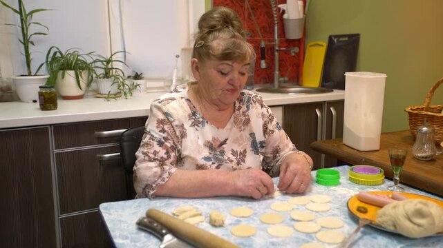 Woman skillfully makes dumplings at home.