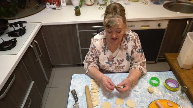 See skilled hands make tasty dumplings.