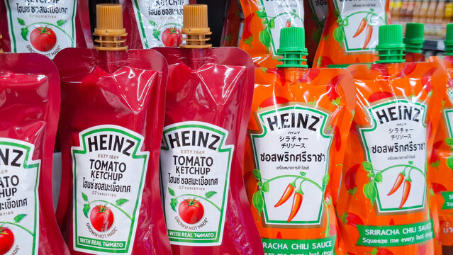 Row of Heinz tomato ketchup and sriracha chili sauce squeeze pouches displayed on supermarket shelf for cooking and food concept on July 24, 2026 in Bangkok,  Thailand