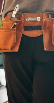 Person, plumber and walking with tools in holster for repair, fixing or installation service. Back view, repairman or tinker with equipment, utility belt or gear for house maintenance or plumbing
