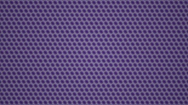 Seamless looping background pattern of repeating purple circles on a solid color