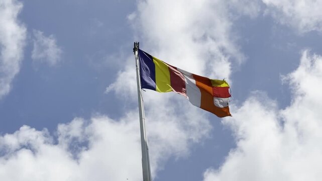Colorful Buddhist Flag Against Clear Blue Sky