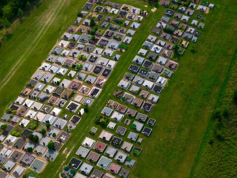 Aerial view of the cemetery in Juzintai featuring orderly rows of gravestones set within a lush green field. Juzintai, Panevezys County, Lithuania.