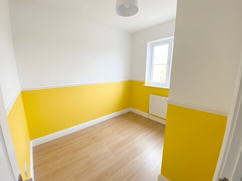 empty room with yellow and white walls | modern nursery interior design ideas | small bedroom with laminate flooring | bright yellow wall paint with dado rail