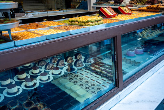 Istanbul, turkey. August 2, 2025. Traditional turkish baklava and various colorful desserts and confections filling a patisserie shop window, inviting customers inside