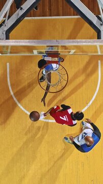 Overhead View of Basketball Players Contesting a Dunk at the Hoop