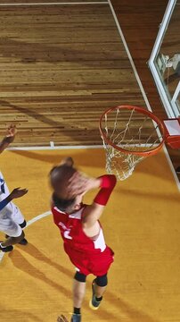 Overhead View of a Basketball Player Dunking the Ball