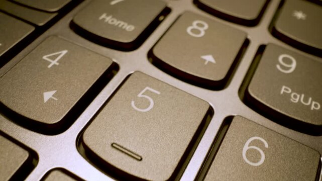 Macro camera sliding over numeric key section of sleek modern laptop keyboard