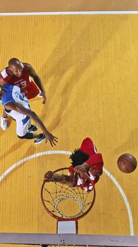 Overhead View of Basketball Players Moving Toward the Hoop for a Rebound