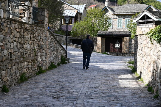 Traditional cobblestone alleyway in Nymfaio village, Greece.